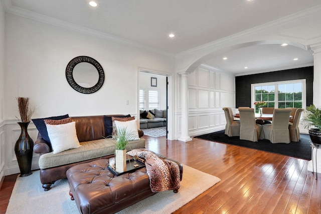 28 Viola Ct, Wappingers Falls, NY 12590 - living area featuring decorative columns, arched walkways, hardwood / wood-style flooring, ornamental molding, and a decorative wall