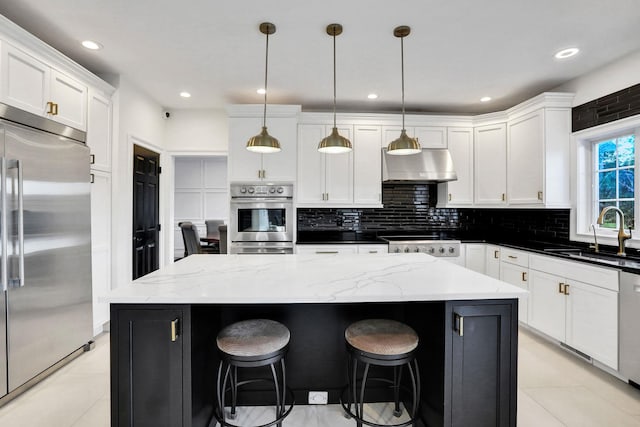 28 Viola Ct, Wappingers Falls, NY 12590 - kitchen with stainless steel appliances, wall chimney range hood, white cabinets, backsplash, and recessed lighting