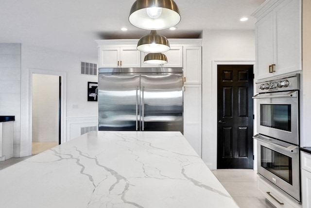 28 Viola Ct, Wappingers Falls, NY 12590 - kitchen with appliances with stainless steel finishes, white cabinets, light stone counters, recessed lighting, and pendant lighting