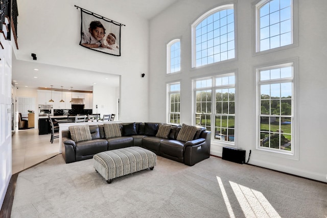 28 Viola Ct, Wappingers Falls, NY 12590 - carpeted living area with healthy amount of natural light, a towering ceiling, and recessed lighting