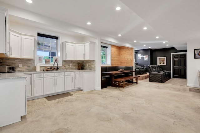 28 Viola Ct, Wappingers Falls, NY 12590 - kitchen featuring recessed lighting, white cabinets, tasteful backsplash, light stone countertops, and concrete floors