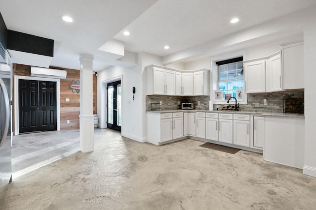 28 Viola Ct, Wappingers Falls, NY 12590 - kitchen featuring tasteful backsplash, white cabinets, a wall mounted AC, ornate columns, and recessed lighting