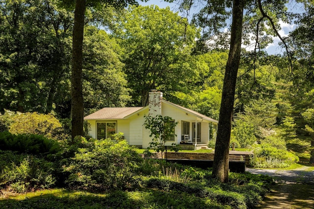 447 Butts Hollow Rd, Dover Plains, NY 12522 - view of property exterior featuring a chimney and a view of trees