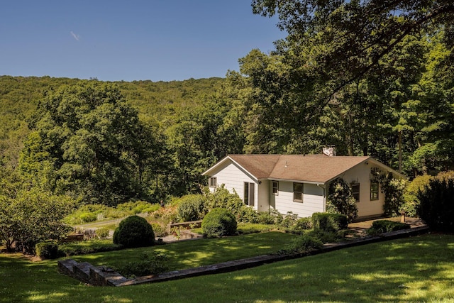 447 Butts Hollow Rd, Dover Plains, NY 12522 - view of side of property featuring a view of trees, a yard, and a chimney