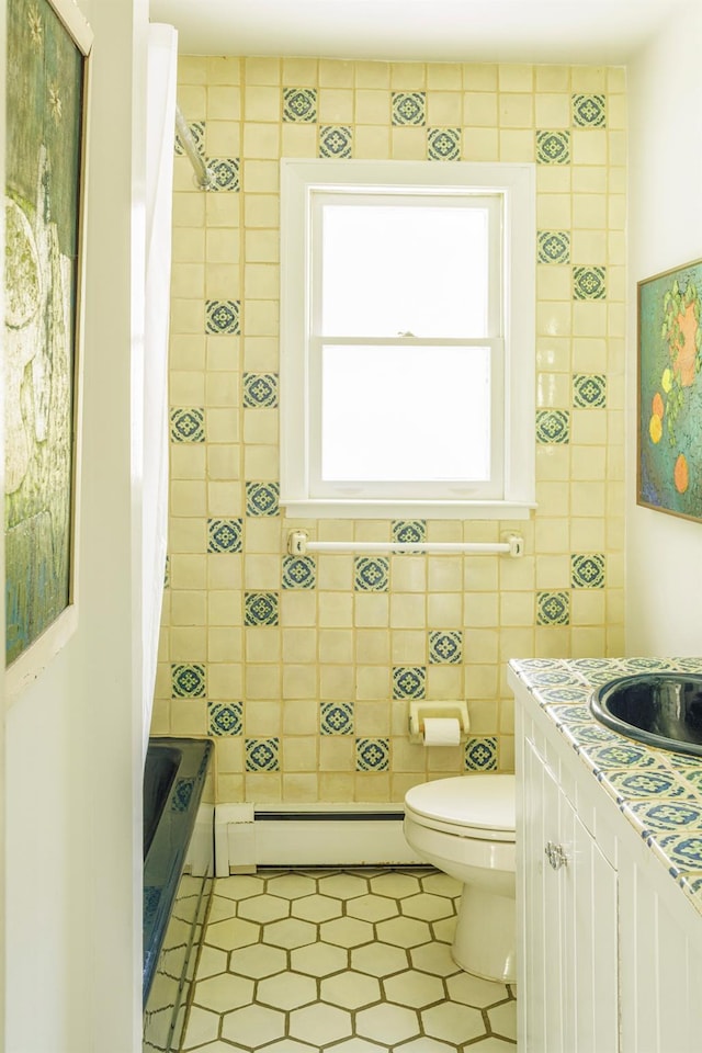 447 Butts Hollow Rd, Dover Plains, NY 12522 - full bathroom featuring a baseboard radiator, tile patterned floors, shower / bathtub combination with curtain, vanity, and tile walls
