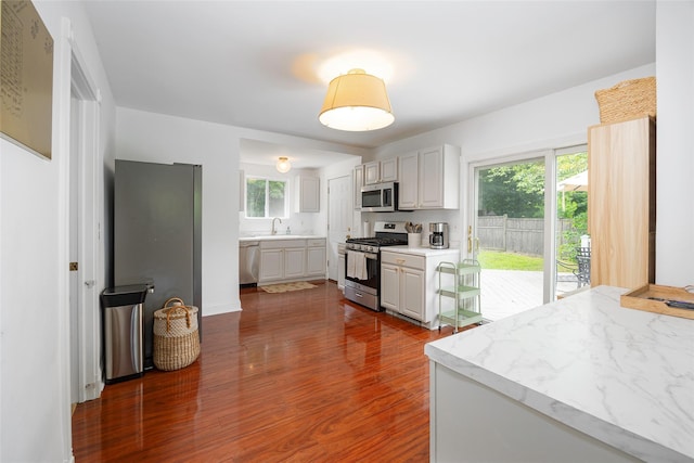 22 Tompkins Ave, Beacon, NY 12508 - kitchen featuring stainless steel appliances, dark wood-style flooring, light countertops, and plenty of natural light