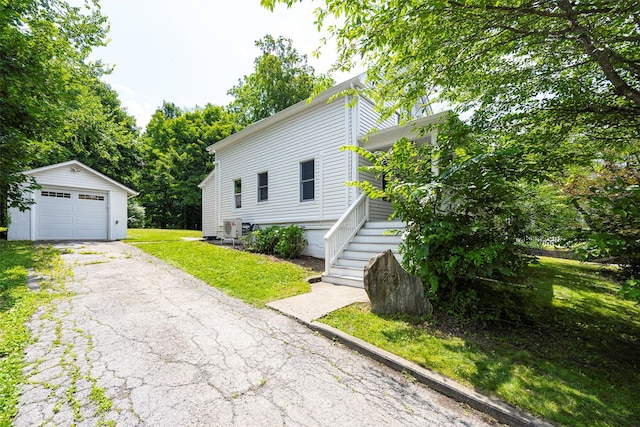 22 Tompkins Ave, Beacon, NY 12508 - view of front facade featuring an outbuilding, a garage, driveway, and a front lawn