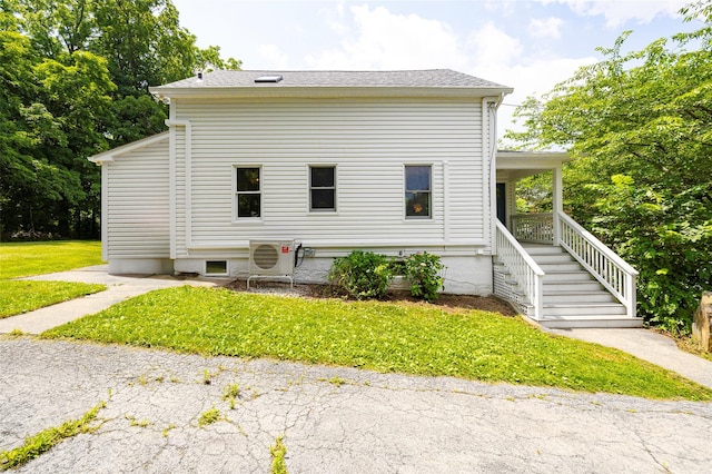 22 Tompkins Ave, Beacon, NY 12508 - view of side of property with a lawn, a porch, and roof with shingles