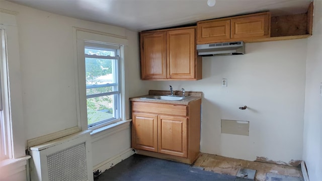 507 S 6th Ave, Mount Vernon, NY 10550 - kitchen with healthy amount of natural light, under cabinet range hood, brown cabinetry, and radiator heating unit