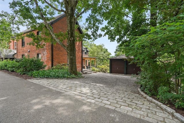 10 King St, Croton-On-Hudson, NY 10520 - view of side of home featuring brick siding, an outdoor structure, and a detached garage