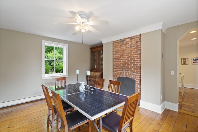 10 King St, Croton-On-Hudson, NY 10520 - dining space featuring ceiling fan, light wood-style flooring, a fireplace, and baseboard heating