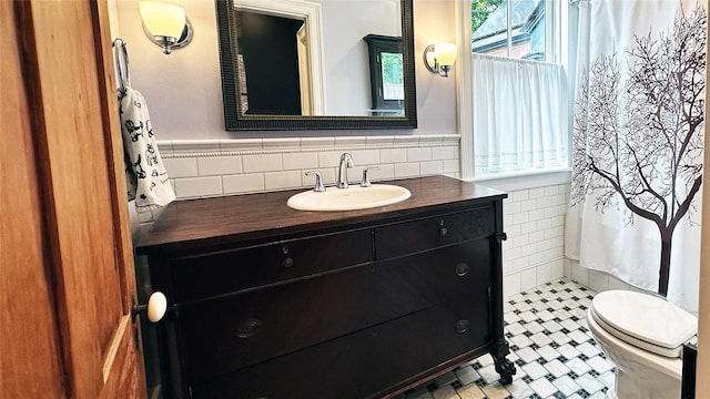 10 King St, Croton-On-Hudson, NY 10520 - bathroom with tile walls, vanity, and wainscoting