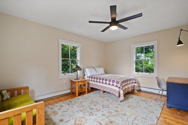 10 King St, Croton-On-Hudson, NY 10520 - bedroom with a baseboard radiator, multiple windows, and hardwood / wood-style floors