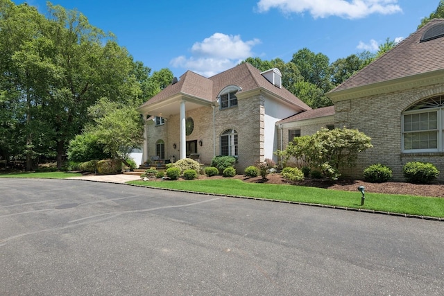 9 Swan Pl, Nissequogue, NY 11780 - view of front of house with brick siding and roof with shingles