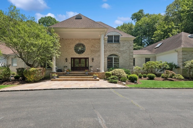 9 Swan Pl, Nissequogue, NY 11780 - view of front of home featuring french doors, brick siding, and roof with shingles