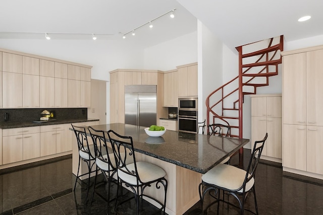 9 Swan Pl, Nissequogue, NY 11780 - kitchen featuring built in appliances, decorative backsplash, modern cabinets, a kitchen breakfast bar, and a high ceiling