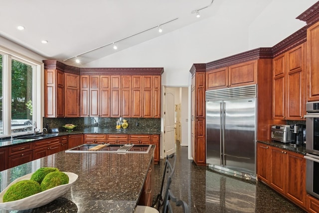 9 Swan Pl, Nissequogue, NY 11780 - kitchen with appliances with stainless steel finishes, granite floors, track lighting, backsplash, and high vaulted ceiling