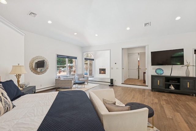 9 Swan Pl, Nissequogue, NY 11780 - bedroom featuring baseboard heating, wood finished floors, and recessed lighting
