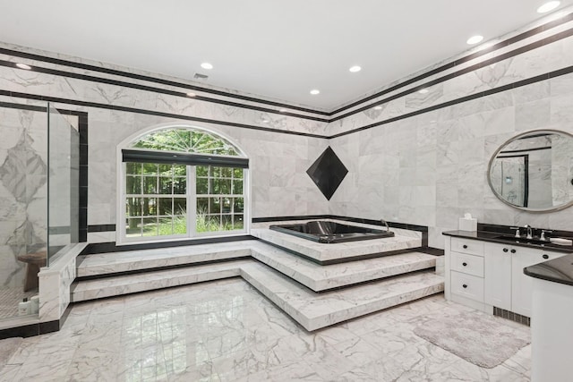 9 Swan Pl, Nissequogue, NY 11780 - bathroom featuring marble tiled flooring, recessed lighting, tile walls, vanity, and a marble finish shower
