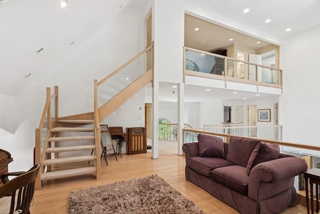 9 Swan Pl, Nissequogue, NY 11780 - living area with wood finished floors, a high ceiling, recessed lighting, and stairway