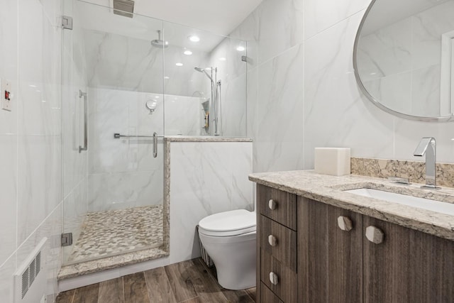 9 Swan Pl, Nissequogue, NY 11780 - bathroom featuring tile walls, wood finished floors, vanity, a marble finish shower, and recessed lighting