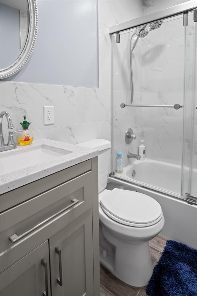 550 Armond St, Uniondale, NY 11553 - bathroom featuring vanity, tile walls, and enclosed tub / shower combo