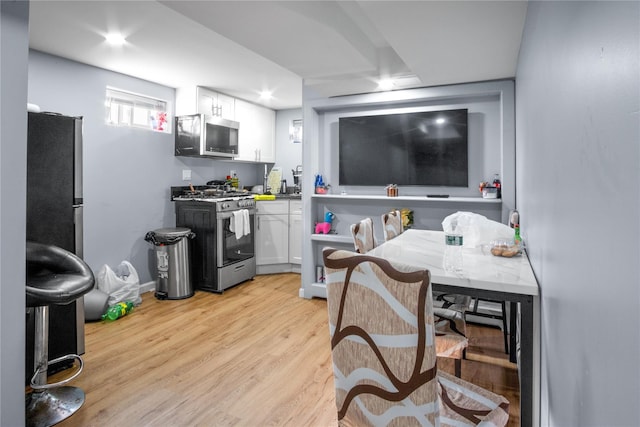 550 Armond St, Uniondale, NY 11553 - kitchen with stainless steel appliances, white cabinetry, light wood finished floors, and recessed lighting