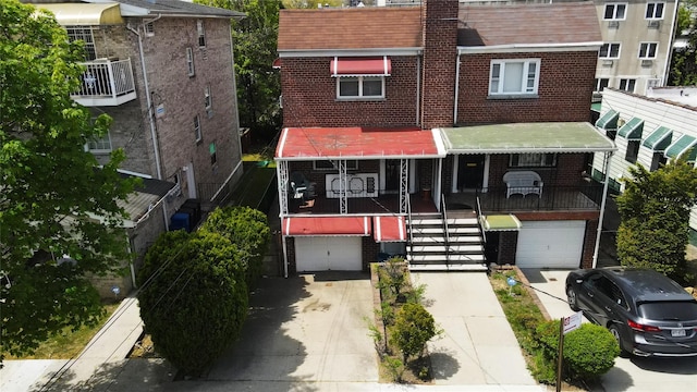 3331 Hone Ave, Bronx, NY 10469 - view of front of property with brick siding, an attached garage, driveway, and stairway