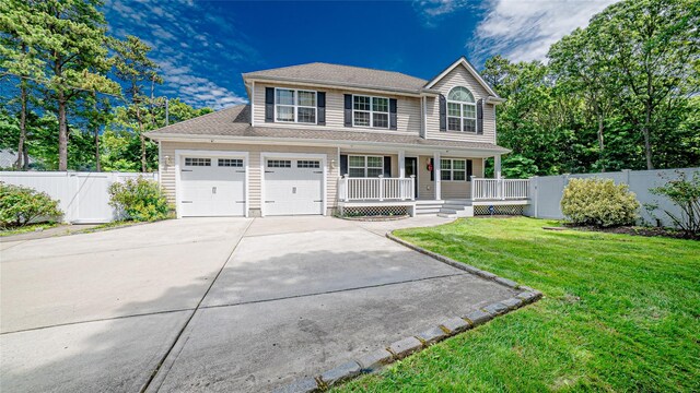 5 Ormond Pl, Mastic, NY 11950 - view of front facade with a porch, concrete driveway, and a garage