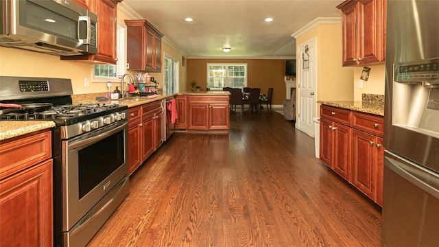 5 Ormond Pl, Mastic, NY 11950 - kitchen with appliances with stainless steel finishes, crown molding, a peninsula, dark wood-type flooring, and recessed lighting