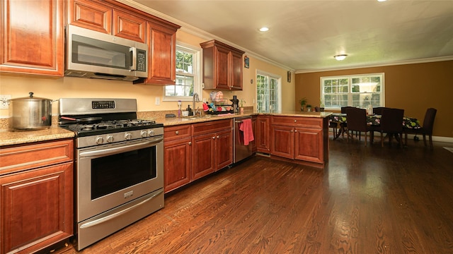 5 Ormond Pl, Mastic, NY 11950 - kitchen with stainless steel appliances, ornamental molding, dark wood finished floors, a peninsula, and healthy amount of natural light