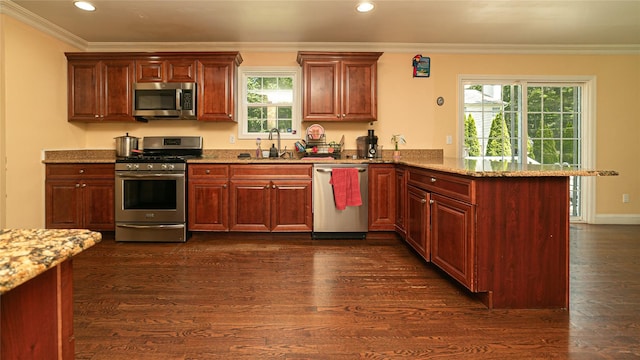 5 Ormond Pl, Mastic, NY 11950 - kitchen with appliances with stainless steel finishes, a peninsula, recessed lighting, dark wood-style floors, and plenty of natural light