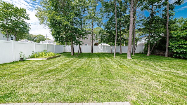 5 Ormond Pl, Mastic, NY 11950 - fenced backyard featuring a vegetable garden