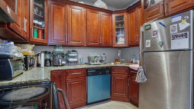 1050 Morris Ave, Bronx, NY 10456 - kitchen with freestanding refrigerator, dishwasher, light stone counters, light tile patterned floors, and glass insert cabinets