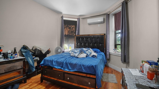 1050 Morris Ave, Bronx, NY 10456 - bedroom with an AC wall unit and wood finished floors
