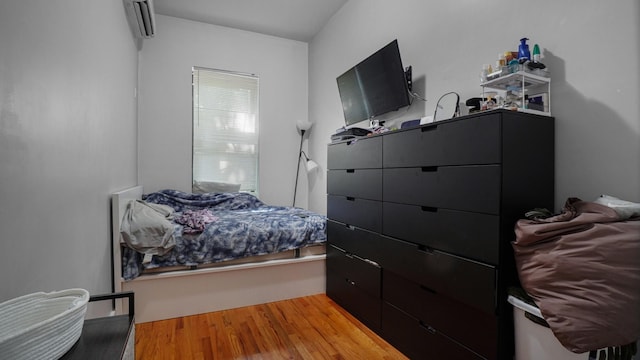 1050 Morris Ave, Bronx, NY 10456 - bedroom featuring an AC wall unit and wood finished floors