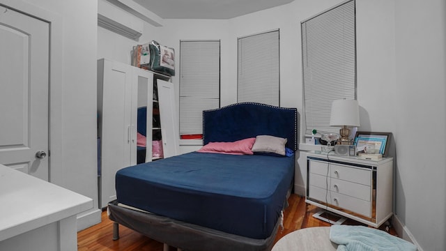1050 Morris Ave, Bronx, NY 10456 - bedroom featuring a wall unit AC and wood finished floors