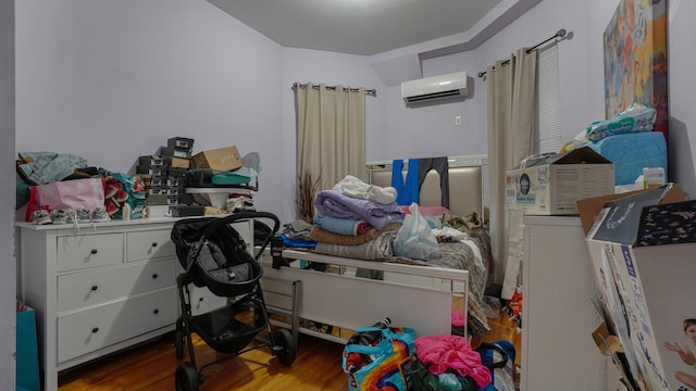 1050 Morris Ave, Bronx, NY 10456 - bedroom featuring a wall mounted air conditioner and wood finished floors