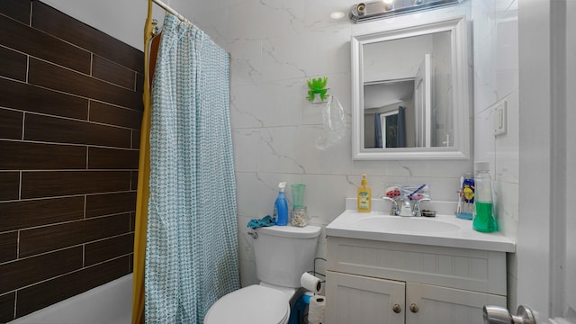 1050 Morris Ave, Bronx, NY 10456 - bathroom featuring tile walls, vanity, shower / bath combo, and decorative backsplash