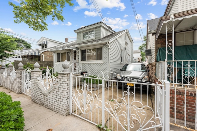 1160 E 89th St, Brooklyn, NY 11236 - view of front facade with a fenced front yard, a gate, and roof with shingles