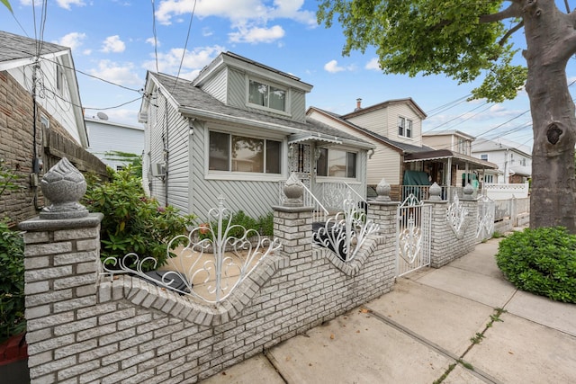 1160 E 89th St, Brooklyn, NY 11236 - view of front of house featuring a fenced front yard, roof with shingles, and a gate