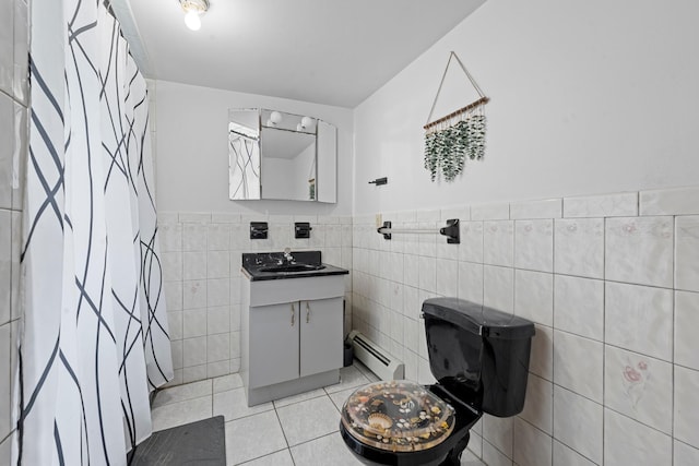 1160 E 89th St, Brooklyn, NY 11236 - bathroom featuring a baseboard radiator, tile walls, vanity, tile patterned floors, and wainscoting