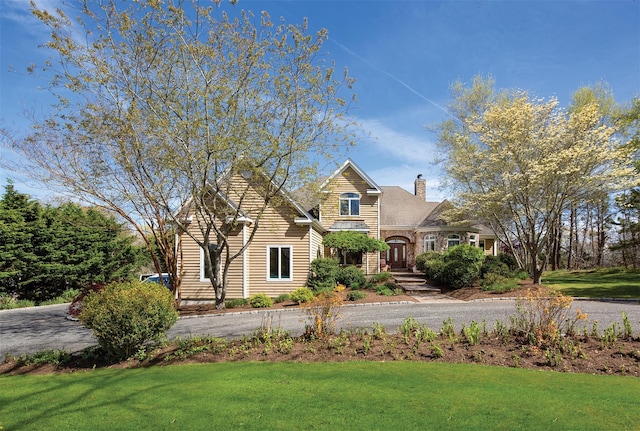 115 Highland Rd, Southampton, NY 11968 - view of front of home featuring a front lawn and a chimney