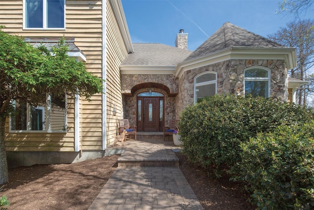 115 Highland Rd, Southampton, NY 11968 - view of exterior entry featuring stone siding and a chimney