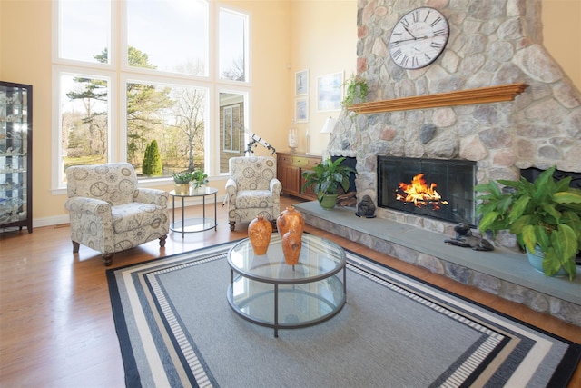 115 Highland Rd, Southampton, NY 11968 - living room featuring a fireplace, healthy amount of natural light, wood finished floors, and a towering ceiling
