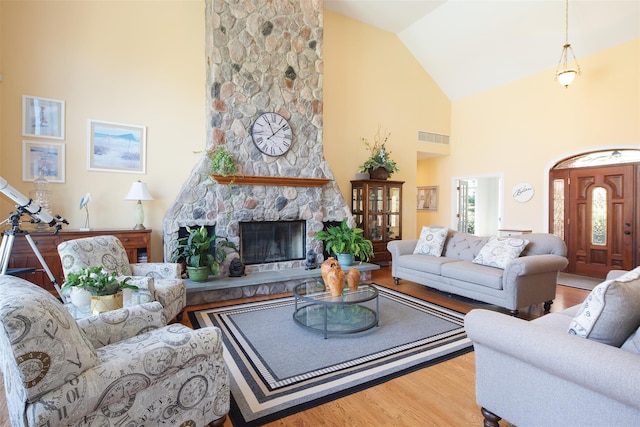 115 Highland Rd, Southampton, NY 11968 - living room featuring high vaulted ceiling, wood finished floors, and a fireplace