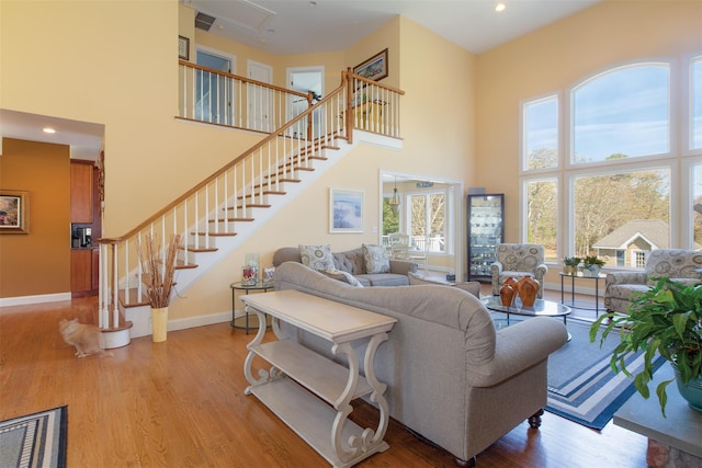 115 Highland Rd, Southampton, NY 11968 - living area with a high ceiling, wood finished floors, stairs, and recessed lighting