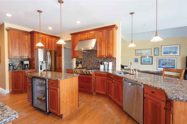 115 Highland Rd, Southampton, NY 11968 - kitchen with stainless steel appliances, beverage cooler, range hood, light wood-type flooring, and decorative backsplash
