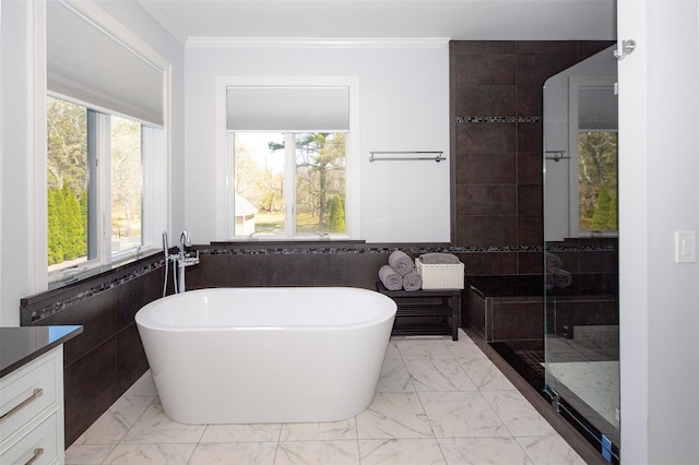 115 Highland Rd, Southampton, NY 11968 - full bath with tile walls, healthy amount of natural light, a soaking tub, marble look tiles, and ornamental molding