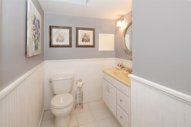 115 Highland Rd, Southampton, NY 11968 - half bathroom featuring vanity, a wainscoted wall, and tile patterned floors